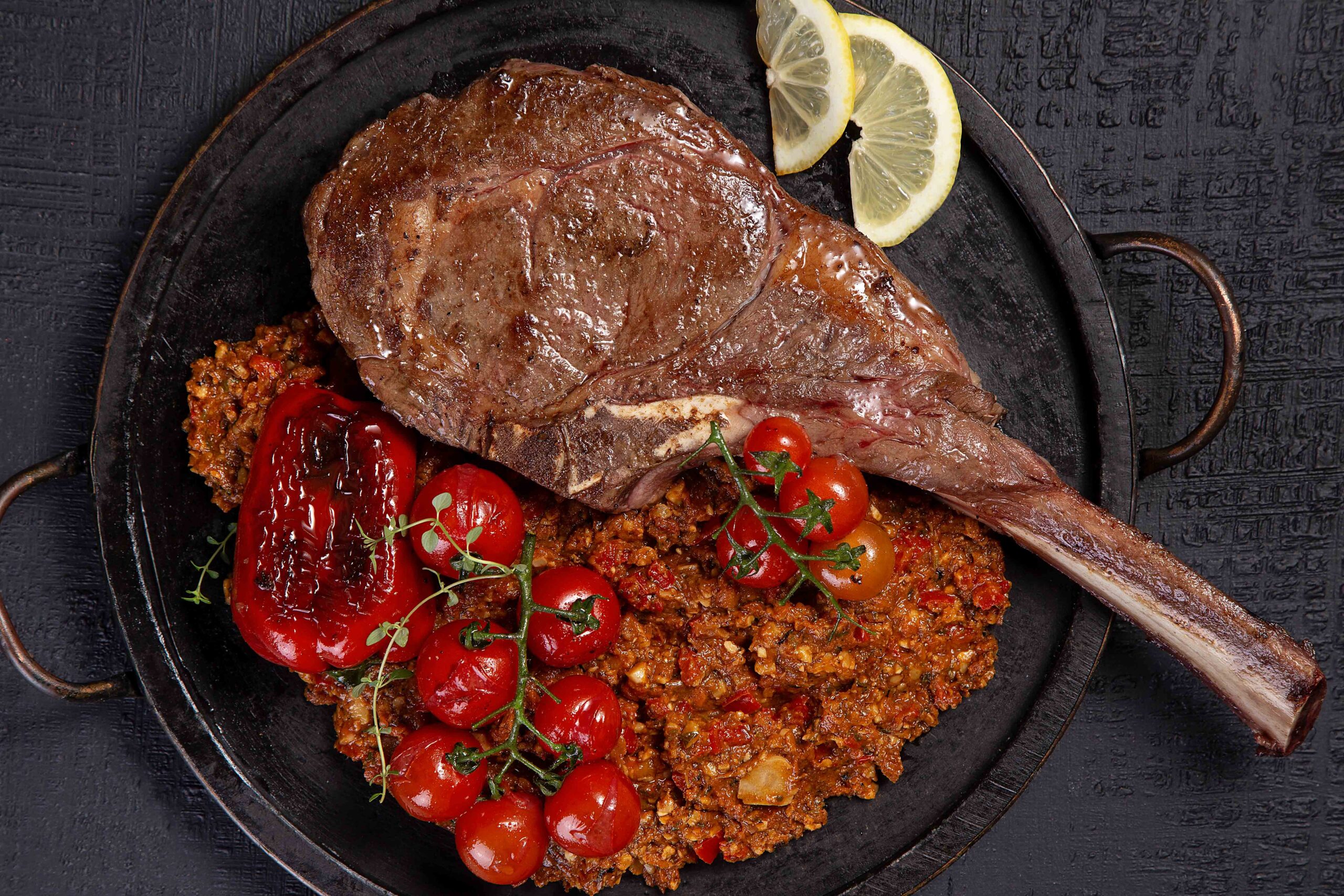 How to make tomahawk with romesco sauce and roasted peppers and tomatoes